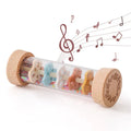 Wooden Montessori rainmaker rattle with colorful beads and musical notes illustration.