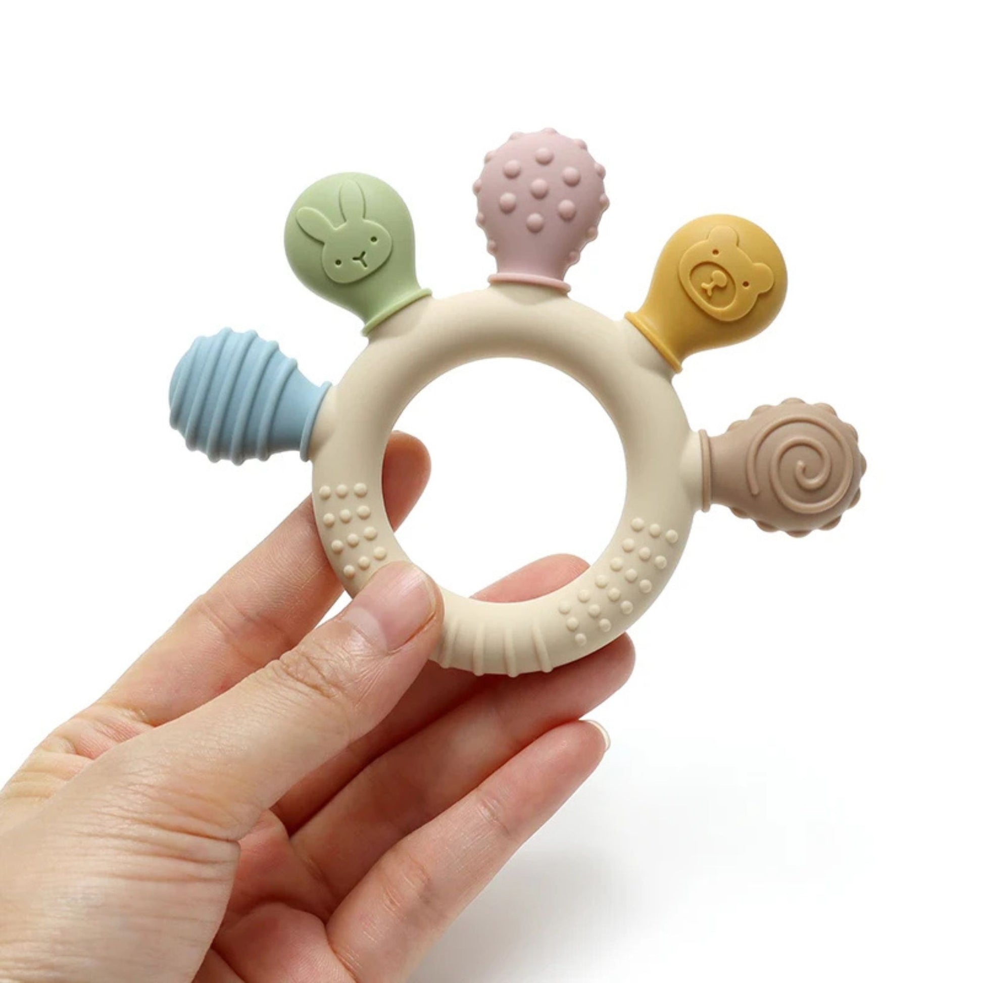 Montessori silicone teething ring with five textured attachments held in hand.