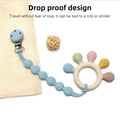 Montessori silicone teething ring with colorful sensory attachments, cream and blue.