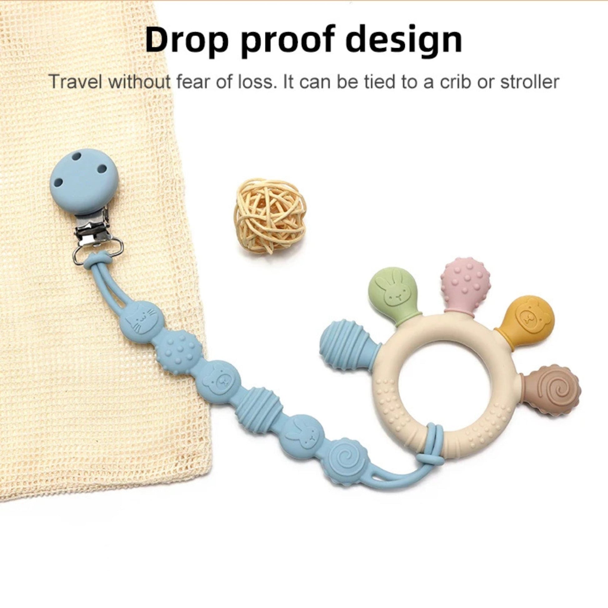 Montessori silicone teething ring with colorful sensory attachments, cream and blue.