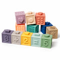 Montessori squeaky building blocks arranged as 3 plus 2 equals 5 with embossed numbers, heart, apple and rabbit.