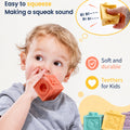 Baby chewing a coral Montessori squeaky building block, showing the squeak sound and soft teething silicone.