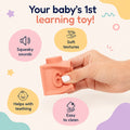 Hand squeezing a coral Montessori squeaky building block showing squeaky sound, soft texture and teething use.